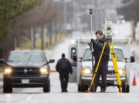 London police officer Blair Jackson investigates at the intersection of Commissioners Road and Grand View Avenue. A pedestrian suffered serious injuries after being struck by a vehicle at about 6:20 a.m. on Friday January 20, 2023. (Mike Hensen/The London Free Press)
