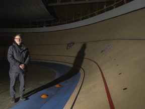 Forest City Velodrome operations manager Rob Fournier stands lit by a single portable light at the darkened track in London on Monday Jan. 23, 2023. 
A thief recently stole the copper wiring that supplied power to the venue, located in the old London Gardens. Mike Hensen/The London Free Press