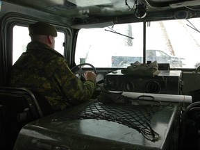 Cpl. John Henderson is shown behind the wheel of a snow vehicle used by the military to access areas during winter storms. (File photo)