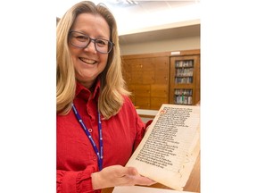 Deborah Meert-Williston, special collections librarian for Western University's library, holds a leaf printed in 1476 by William Caxton in England. The leaf was recently acquired by the university's archives special collections. Photograph taken on Friday, Jan. 13, 2023. (Mike Hensen/The London Free Press)