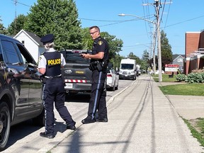 Lambton OPP officers are stationed in front of Lambton Central Collegiate and Vocational School in Petrolia on June 2, 2022. A student, who can’t be identified, was convicted Wednesday of uttering threats in youth court and was sentenced to a judicial reprimand. Terry Bridge/Sarnia Observer/Postmedia Network