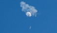 The suspected Chinese spy balloon drifts to the ocean after being shot down off the coast in Surfside Beach, S.C., on Feb. 4,, 2023. (Randall Hall/Reuters)