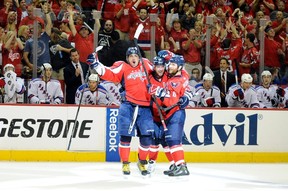 Mike Green (52) of the Washington Capitals, celebrates with Alex Ovechkin (8) and Dennis Wideman (6) after scoring the game-winning goal against the New York Rangers in Game 4 of the Eastern Conference semifinals during the 2012 NHL Stanley Cup playoffs at the Verizon Centre on May 5, 2012, in Washington. Washington won the game 3-2. (Photo by Greg Fiume/Getty Images)