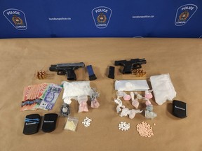 London police seized nearly $40,000 in drugs and two loaded handguns after an armed robbery investigation involving a vehicle theft led officers to search a home on Kiwanis Park Drive Monday. Two men are facing a series of gun and drug charges. (Supplied/London Police)