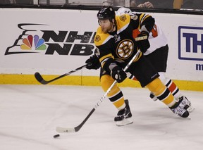 Boston Bruins defenseman Dennis Wideman (6) keeps the puck away from Philadelphia Flyers defenseman Lukas Krajicek (2) in Game 1 of the Eastern Conference semifinals in the 2010 Stanley Cup Playoffs at TD Garden in Boston, Mass, on Saturday, May 1, 2010. (Files)