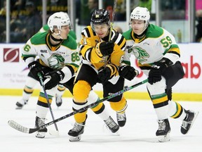 Sarnia Sting player Christian Kyrou (61) is sandwiched by London Knights opponents Denver Barkey (86) and Oliver Bonk (59) in the first period at Progressive Auto Sales Arena in Sarnia on Saturday, Feb. 18, 2023. Mark Malone/Chatham Daily News/Postmedia Network