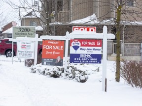 For sale signs in front of three homes on Springmeadow Road in London on Thursday, Jan. 26, 2023. (Derek Ruttan/The London Free Press)