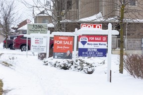 For sale signs in front of three homes on Springmeadow Road in London on Thursday, Jan. 26, 2023. (Derek Ruttan/The London Free Press)