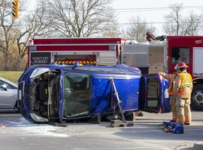 Two people were taken to hospital after a car and SUV collided at the intersection of Riverside Drive and Wonderland Road in London on Tuesday, Feb. 14, 2023. (Derek Ruttan/The London Free Press)