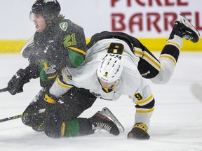 Cooper Way of the Sarnia Sting flips over Ryan Humphrey  of the London Knights during  their game at Budweiser Gardens in London on Friday February 17, 2023. Derek Ruttan/The London Free Press