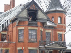 Firefighters dowsed a fire in the attic of a house at the corner of Dufferin Avenue and Waterloo Street in London on Thursday February 23, 2023. No one was injured. (Derek Ruttan/The London Free Press)