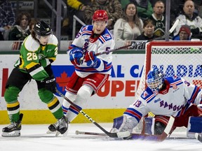 Ryan Winterton of the London Knights tries a wraparound on Kitchener Rangers goalie Marco Costantini while being chased by Matthew Andonovski in a game at Budweiser Gardens in London on Wednesday, Feb. 8, 2023. (Mike Hensen/The London Free Press)