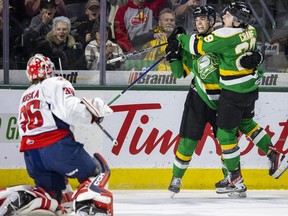 Jacob Julien celebrates his first period goal against the Windsor Spitfires with London Knights teammate Brody Crane at Budweiser Gardens on Monday Feb. 20, 2023. Mike Hensen/The London Free Press
