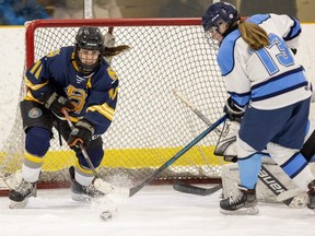 Olivia Battram of the Strathroy Saints can't get her stick on the puck with an open net as Lucas Vikings player Reagan Nolan gets it to safety during TVRA girls high school hockey semifinal action at Stronach Arena in London. Photo taken on Friday Feb. 24, 2023. (Mike Hensen/The London Free Press)
