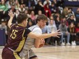 Kaiden Gale of the Parkside Stampeders looks for an outlet while being guarded by Petar Orelj of the Banting Broncos in a WOSSAA boys semifinal at Lucas secondary school on Monday, Feb. 27, 2023. (Mike Hensen/The London Free Press)