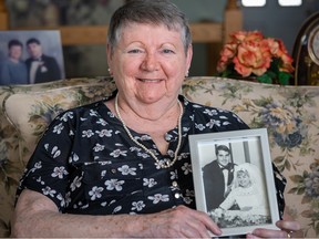 Elizabeth Welch holds a framed wedding photo of her and her husband Gary, who had Parkinson’s for 23 years and passed away last year. Supplied
