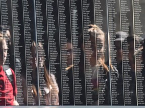 Visitors are reflected by the black marble stone with the names of Holocaust victims in the Holocaust Memorial Centre in Budapest, Hungary, on April 16, 2019, prior to the Holocaust memorial day. (ATTILA KISBENEDEK/AFP via Getty Images)