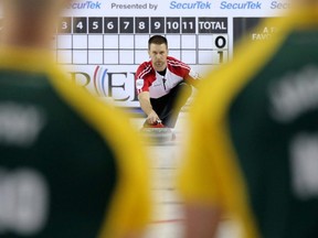 Team Newfoundland/Labrador skip Brad Gushue makes a shot in the page playoff game against Team Northern Ontario at the Tim Hortons Brier 2015 at the Scotiabank Saddledome in Calgary, Alberta, on March 6, 2015. (Mike Drew/Postmedia Network)