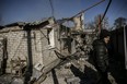 A man stands in front of a house destroyed by shelling in the village of Chasiv Yar near Bakhmut, on March 14, 2023.  (Photo by ARIS MESSINIS/AFP via Getty Images)