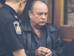A handcuffed Erland Mordue is shown in this 2006 Postmedia file photo
