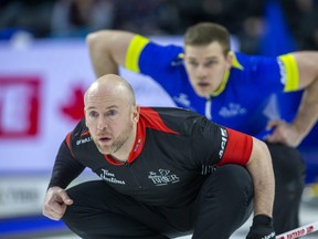 Ontario third Ryan Fry and Alberta second Brad Thiessen watch a rock come toward them at the Tim Hortons Brier at Budweiser Gardens on Friday, March 10, 2023.  (Derek Ruttan/The London Free Press)