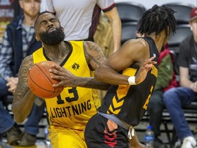 Terry Thomas of The London Lightning collides with AJ Mosby of The Sudbury Five during Wednesday night's game at Budweiser Gardens in London. The Bolts bowed 113-102 for their second straight loss., (Derek Ruttan/The London Free Press)