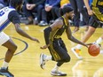 Marcus Ottey of the London Lightning speeds past Elijah Ifejeh of the Kitchener-Waterloo Titans in National Basketball League of Canada action at Budweiser Gardens in London on Thursday, March 16, 2023. (Derek Ruttan/The London Free Press)