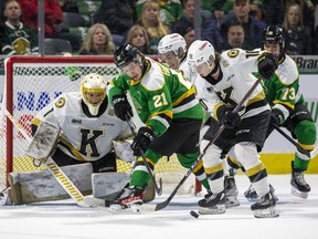 London Knights player Ryan Humphrey reaches for the puck amid a scramble in front of the Kingston Frontenacs net during their Ontario Hockey League game at Budweiser Gardens in London on Friday March 17, 2023. Also in the photo are Kingston's Mason Vaccari (in net) and Duncan Schneider and Knights player William Nicholl. Derek Ruttan/The London Free Press/Postmedia Network