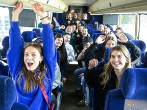 Members of the Medway Cowboys girls hockey team excitedly wait in Arva on Monday March 20, 2023, for their charter bus to start rolling its way to Windsor where they will compete in the OFSAA championship tournament. (Derek Ruttan/The London Free Press)