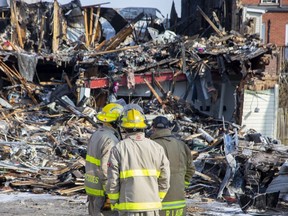 Aylmer firefighters survey a building on Talbot Street in the town's downtown that was destroyed in a fire that began at about 8:20 p.m. Monday. Photo taken on Tuesday, March 21, 2023. (Derek Ruttan/The London Free Press)