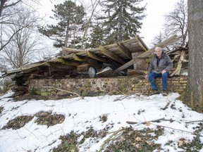 John McLeod with the remnants of a barn on his property in London on Wednesday March 22, 2023. He says city hall wants him to remove the debris by hand to avoid damaging a crumbling wall. (Derek Ruttan/The London Free Press)