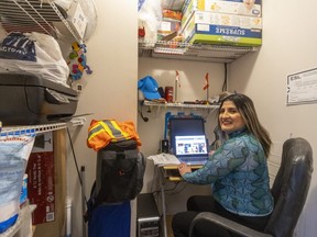 Carmen Pardo Pinto sits in her office inside a walk-in closet at her family's London apartment. "When I need to be quiet, I have my own office," she said. An immigrant who worked in computer science in her native Colombia, Pinto recently graduated from the IgniteHER program in London that prepares women for tech jobs. Photograph taken on Friday, March 3, 2023. (Mike Hensen/The London Free Press)