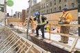 Chris Fidler and Ben Braun pour concrete on York Street in downtown London on Thursday, March 16, 2023. A Conference Board of Canada forecast predicts slower growth for the city due to inflation and interest rate increases. (Mike Hensen/The London Free Press)