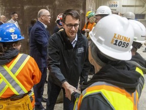Monte McNaughton, Ontario minister of labour, immigration, training and skills development, greets students at a LiUNA training centre in London on Wednesday, March 15, 2023. McNaughton announced new workplace mandates that make female-only washrooms mandatory on construction sites. (Mike Hensen/The London Free Press)