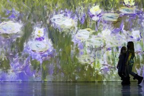 Sophia Beaudoin, 5, and her older sister Amelia, 8, frolic in Monet's water lilies.