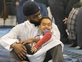 Hafez Farah kisses his son Malik, 4, after they attended afternoon prayers at the London Muslim Mosque on Thursday, March 23, 2023. Farah said they “were enjoying the day together, and came to the mosque for prayers before his doctor's appointment” for a recently broken arm. (Mike Hensen/The London Free Press)