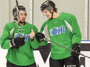 London Knight Max McCue, right, seen here chatting with co-captain George Diaco during a recent practice, vows to play "his game," hard and physical, when the Knights begin their second-round series with the Kitchener Rangers at Budweiser Gardens Thursday night. (Mike Hensen/The London Free Press)