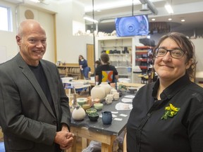 John White, a board member who led the rebranding of the London Potters Guild and the London Clay Art Centre, stands with Clayworx executive director Bep Schippers in the upstairs classroom at their facility at 664 Dundas St.  in London on Friday, March 31, 2023.  (Mike Hensen/The London Free Press)