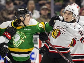 Landon Sim of the London Knights gets in the face of Owen Sound Attack player James Petrovski early in the first game of their first-round OHL playoff series at Budweiser Gardens in London on Friday, March 31, 2023. (Mike Hensen/The London Free Press)