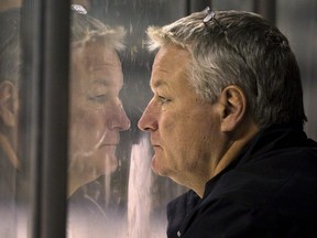 London Knights head coach Dale Hunter fogs up the glass as he stares intently at a scrimmage during their training camp at Budweiser Gardens on Wednesday Aug 28, 2013. (MIKE HENSEN/The London Free Press)