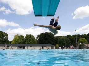 An adventurous swimmer flips off a diving board at Thames pool in London in this Free Press file photo.