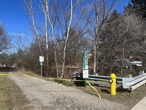 London police remained at the scene of a park entrance in the 100-block of Base Line Road West on Sunday March 26, 2023. Police have launched a suspicious death investigation after a deceased man was found the day before. (Jennifer Bieman/The London Free Press)