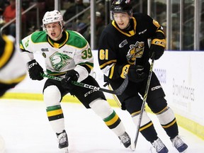 Sarnia Sting player Christian Kyrou (61) is chased by London Knights player Max McCue (39) behind the Sting's net in the second period at Progressive Auto Sales Arena in Sarnia, Ont., on Friday, March 3, 2023. (Mark Malone/Chatham Daily News/Postmedia Network)