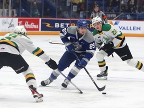 Nathan Villeneuve, middle, of the Sudbury Wolves, breaks between Easton Cowan, left, and Ryan Winterton, of the London Knights, during OHL action at the Sudbury Community Arena in Sudbury, Ont. on Friday March 10, 2023. John Lappa/Sudbury Star/Postmedia Network