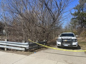 London police remained at the scene of a park entrance on Base Line Road West near Beachwood Avenue on Sunday, March 26, 2023, a day after a man's body was discovered. Police identified the deceased as Levi Jordan Brown, 36, of London and are investigating the death as a homicide. (Jennifer Bieman/The London Free Press)