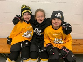 Three youth hockey players in West Lorne were all smiles in their locker room. (Facebook)