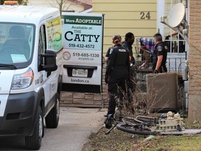 Police remove a dog from a home on Dudley Crescent after a woman was seriously injured in a dog attack on Tuesday, April 4, 2023. (Dale Carruthers/The London Free Press)