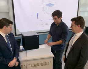 Western grad Ari Forman, left, and Prof Francois Lagugne-Labarthet, flank Toronto Metropolitan University grad Alex Boukin as he demonstrates a new street drug-testing device that will be installed at safe drug-use site in London and across Canada thanks to a $1.9-million federal grant announced Friday. (Randy Richmond/The London Free Press)