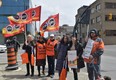 Barb Pawlovich, second vice-president for the union of taxation employees, third from left, and Mandy Forgét, an administrative assistant with the 31 Service Battalion and local president for the Union of National Defence Employees (UNDE), second from left, join other federal workers on the picket line outside 451 Talbot St. in London on Thursday, April 20, 2023. (Calvi Leon/The London Free Press)