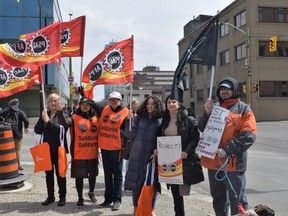 Barb Pawlovich, second vice-president for the union of taxation employees, third from left, and Mandy Forgét, an administrative assistant with the 31 Service Battalion and local president for the Union of National Defence Employees (UNDE), second from left, join other federal workers on the picket line outside 451 Talbot St. in London on Thursday, April 20, 2023. (Calvi Leon/The London Free Press)
